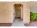 Inviting front entrance with security door and textured stucco exterior at 8408 Running Deer Ave # 103, Las Vegas, NV 89145