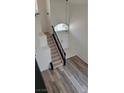 Bright entryway showcasing the staircase with dark wood trim and decorative lighting at 9008 Cotton Rose Way, Las Vegas, NV 89134