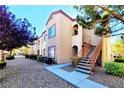 Attractive apartment building with well-maintained landscaping and exterior staircase at 9580 W Reno Ave # 211, Las Vegas, NV 89148