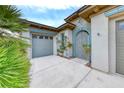 Beautifully designed single-story home with a charming gated entrance and a two-car garage at 10479 Garden Light Dr, Las Vegas, NV 89135