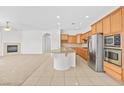 Inviting open-concept space with a modern kitchen, cozy fireplace, and ample natural light, perfect for gatherings at 11298 Merado Peak Dr, Las Vegas, NV 89135