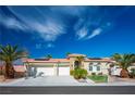 Charming single-story home with a three-car garage, lush landscaping, and a well-manicured lawn at 1516 Barrington Oaks St, North Las Vegas, NV 89084