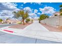 A beautiful single-story home with a long driveway and desert landscaping at 1516 Dusty Canyon St, Henderson, NV 89052