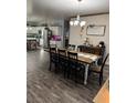 Open dining room features a rustic wood table, elegant chandelier, and stylish decor adjacent to the kitchen at 170 Magnolia Blvd, Pahrump, NV 89048