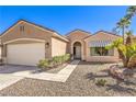 Inviting one-story house with a well-kept front yard and an attached two-car garage at 1821 Eagle Mesa Ave, Henderson, NV 89012