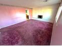 Living room features a decorative fireplace and plush carpet at 2208 E Ogden Ave, Las Vegas, NV 89101