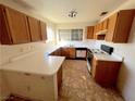 Functional kitchen featuring ample counter space, cabinetry, white appliances, and a bright window at 2228 Saint Paul Way, Las Vegas, NV 89104