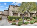 A well-manicured lawn and mature trees enhance this attractive home's curb appeal at 2231 Desert Prairie St, Las Vegas, NV 89135