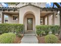 Inviting front entrance with an arched doorway and manicured landscaping at 2231 Desert Prairie St, Las Vegas, NV 89135
