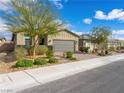 Single-story home with brick paved driveway, desert landscaping, and a well-maintained front yard at 2376 Thelen Ave, North Las Vegas, NV 89086