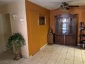 A living room featuring tile flooring and a decorative china cabinet at 2425 Paradise Village Way, Las Vegas, NV 89120