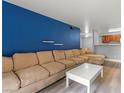 Spacious living room with sleek floors, blue accent wall, open to the kitchen at 2451 N Rainbow Blvd # 2067, Las Vegas, NV 89108