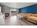 Cozy living room with a fireplace, sliding glass doors, and a comfortable, modern sofa at 2451 N Rainbow Blvd # 2067, Las Vegas, NV 89108