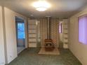 View of the living room with a fireplace, shelving and window at 3100 Sequoia Ave, Las Vegas, NV 89101