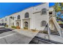Exterior shot of building featuring unique arched windows, stairs, and stucco facade at 3125 N Buffalo Dr # 1105, Las Vegas, NV 89128