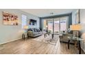 Cozy living room featuring neutral tones, stylish decor, and sliding glass doors to the patio at 320 San Antonio River St, North Las Vegas, NV 89084