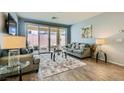 Comfortable living room with modern furnishings and a view of the outdoor space through sliding doors at 320 San Antonio River St, North Las Vegas, NV 89084