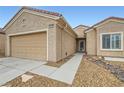 Well-maintained single-story home with a two-car garage and desert-style landscaping at 3220 Flinthead Dr, North Las Vegas, NV 89084