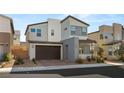 Contemporary two-story home featuring a dark brown two-car garage and stylish gray accents at 3243 Fountaintree Ave, Henderson, NV 89044