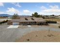 Inviting single-story home with manicured front yard and an attached garage at 3450 Oakleaf Ave, Pahrump, NV 89048