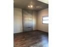 Modern bedroom with wood floors, a large window, and industrial-style decor at 353 E Bonneville Ave # 621, Las Vegas, NV 89101