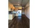Stylish kitchen with wood cabinets, stainless steel appliances, and dark wood floors at 353 E Bonneville Ave # 621, Las Vegas, NV 89101