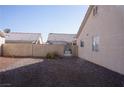 The backyard features gravel landscaping with block wall fencing and a gate at 3745 Saint Peter Ct, North Las Vegas, NV 89031