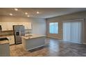 Modern kitchen with stainless steel appliances, granite countertops, and a central island at 3816 Seyfert Ave, North Las Vegas, NV 89084