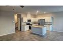 Open concept kitchen with granite countertops, modern appliances, and ample cabinet space at 3816 Seyfert Ave, North Las Vegas, NV 89084
