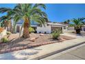 Two-story home featuring mature landscaping with palm trees and easy-care gravel at 3953 E Reno Ave, Las Vegas, NV 89120