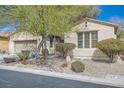 Beautiful one-story home boasting desert landscaping, an attached garage and mature landscaping at 4408 Oasis Hill Ave, North Las Vegas, NV 89085