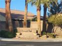 Community entrance sign for Prescott Park, featuring manicured landscaping and palm trees at 4408 Oasis Hill Ave, North Las Vegas, NV 89085