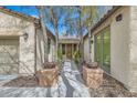 Inviting walkway between homes, landscaped with desert plants, leading to the front door at 4408 Oasis Hill Ave, North Las Vegas, NV 89085