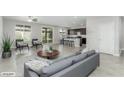 Open floor plan showcases a living room with tile floors that leads into the kitchen at 4512 Moon Hill Rock Ave, North Las Vegas, NV 89084