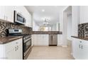 Beautiful kitchen with stainless steel appliances, white cabinets, and stylish backsplash at 4546 Regalo Bello St, Las Vegas, NV 89135