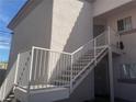 Exterior staircase with white railings leading to upper-level units provides access and architectural detail at 4555 E Sahara Ave # 288, Las Vegas, NV 89104