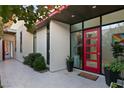 Contemporary home's front entrance with a red door, desert landscaping, and modern architectural design at 515 Serenity Point Dr, Henderson, NV 89012