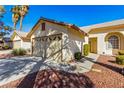 Single Gathering home featuring a desert landscape, a spacious driveway, and two-car garage at 5448 Cove Point Dr, Las Vegas, NV 89130