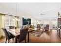 Bright living room and dining area with stylish furniture and hardwood floors at 5448 Cove Point Dr, Las Vegas, NV 89130