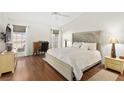 Inviting primary bedroom with hardwood floors, a large bed, and ample natural light at 5448 Cove Point Dr, Las Vegas, NV 89130