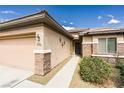 Welcoming home featuring a two-car garage and well-kept front yard, showcasing desert landscaping at 5944 Saddle Horse Ave, Las Vegas, NV 89122