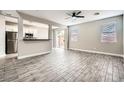 Bright living room featuring neutral paint, and wood-look tile flooring at 6342 War Emblem Ct, Las Vegas, NV 89141