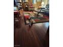 Cozy living room with hardwood floors, colorful rug, comfortable seating, and bookshelf at 6429 Hill View Ave, Las Vegas, NV 89107