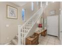 Inviting foyer features a staircase with white railings and landing with decorative art at 682 Baffin Island Rd, Henderson, NV 89011