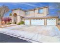 Spacious three-car garage and driveway of this two-story home featuring desert landscaping at 694 Tomscott Ave, Henderson, NV 89052