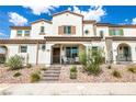 Attractive two-story townhome featuring a covered entryway, a brown tiled roof, and desert rock landscaping at 795 Pickled Pepper Pl, Henderson, NV 89011