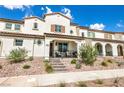 Inviting townhome exterior with covered porch, desert landscaping, and neutral color scheme at 795 Pickled Pepper Pl, Henderson, NV 89011