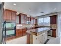 Charming kitchen with custom cabinets, granite countertops, a large island and stainless steel appliances at 9003 Greek Palace Ave, Las Vegas, NV 89178