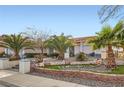 Inviting single-story home with a terracotta tile roof, mature palm trees, and well-maintained landscaping at 905 White Thunder St, Henderson, NV 89002