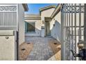 Private courtyard featuring beautiful pavers that lead to a modern front door at 9570 Verde Way, Las Vegas, NV 89149